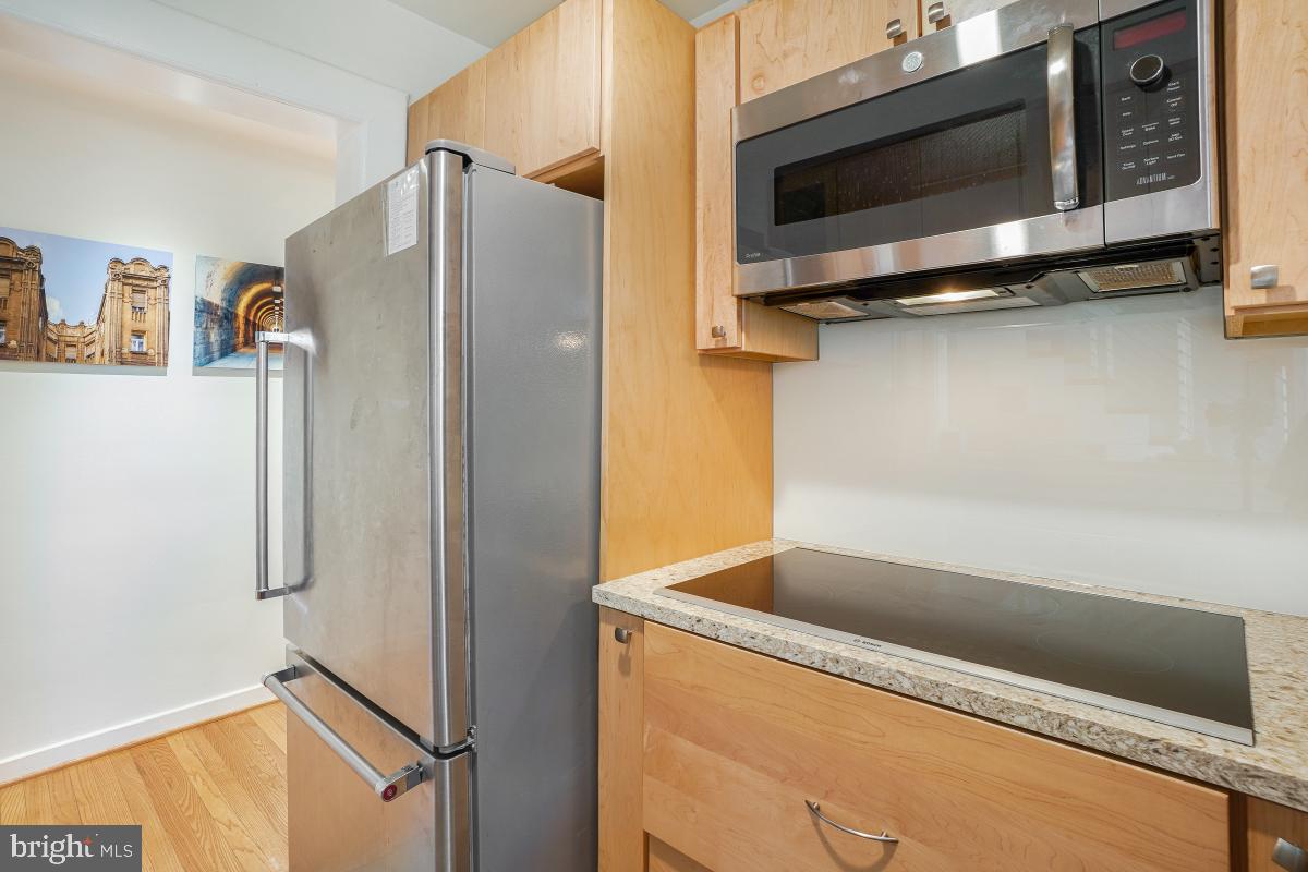 8335 Grubb Road, Unit 203 Silver Spring, MD 20910 - Photo 8 of 29 a kitchen with a refrigerator and a microwave