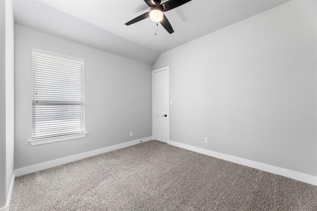 1533 Lynx Loop Forney, TX 75126 - Photo 13 of 27 an empty room with a window and a ceiling fan