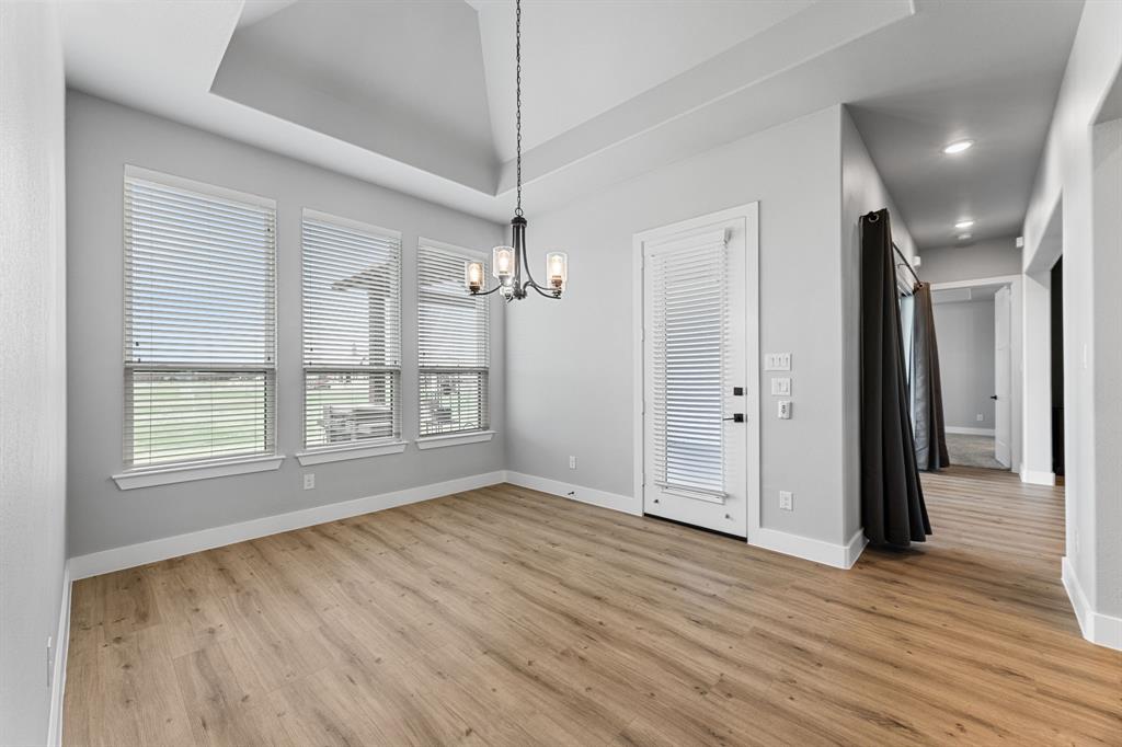 1533 Lynx Loop Forney, TX 75126 - Photo 20 of 27 a view of an empty room with wooden floor and a window