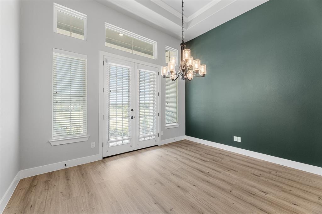 1533 Lynx Loop Forney, TX 75126 - Photo 8 of 27 wooden floor in an empty room with a window