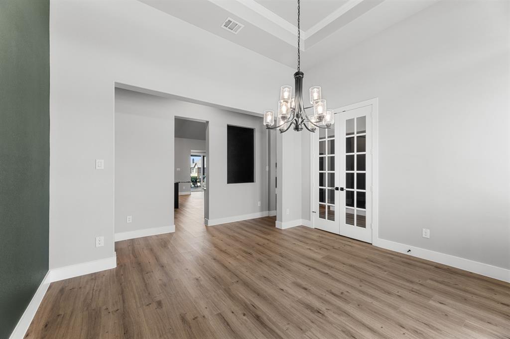 1533 Lynx Loop Forney, TX 75126 - Photo 9 of 27 a view of a livingroom with wooden floor and chandelier