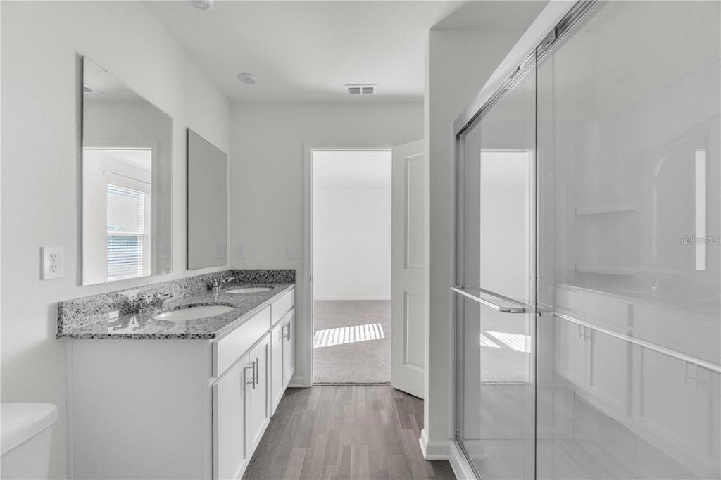 1623 Indiana Loop Sumterville, FL 33585 - Photo 3 of 6 a bathroom with a granite countertop sink and a mirror
