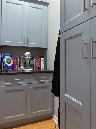 a cabinet with wide window and refrigerator