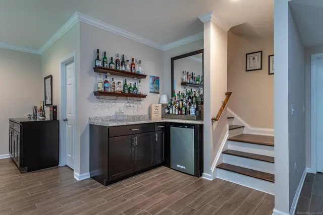 a living room with furniture and a book shelf