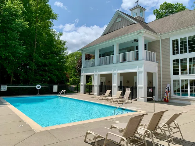 a view of a house with swimming pool and porch with furniture
