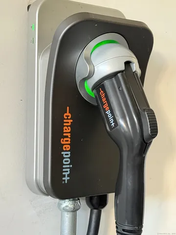 a bedroom with furniture and a large window