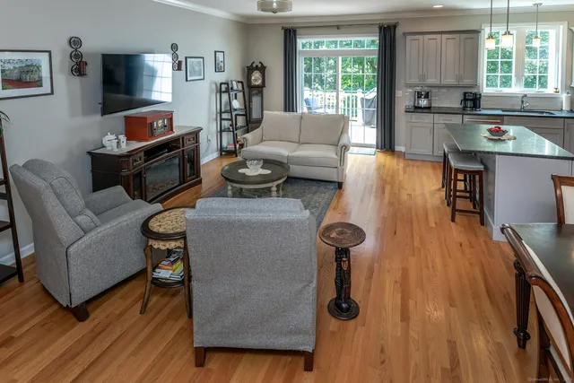 a kitchen with stainless steel appliances granite countertop a stove a sink a microwave a center island and chairs