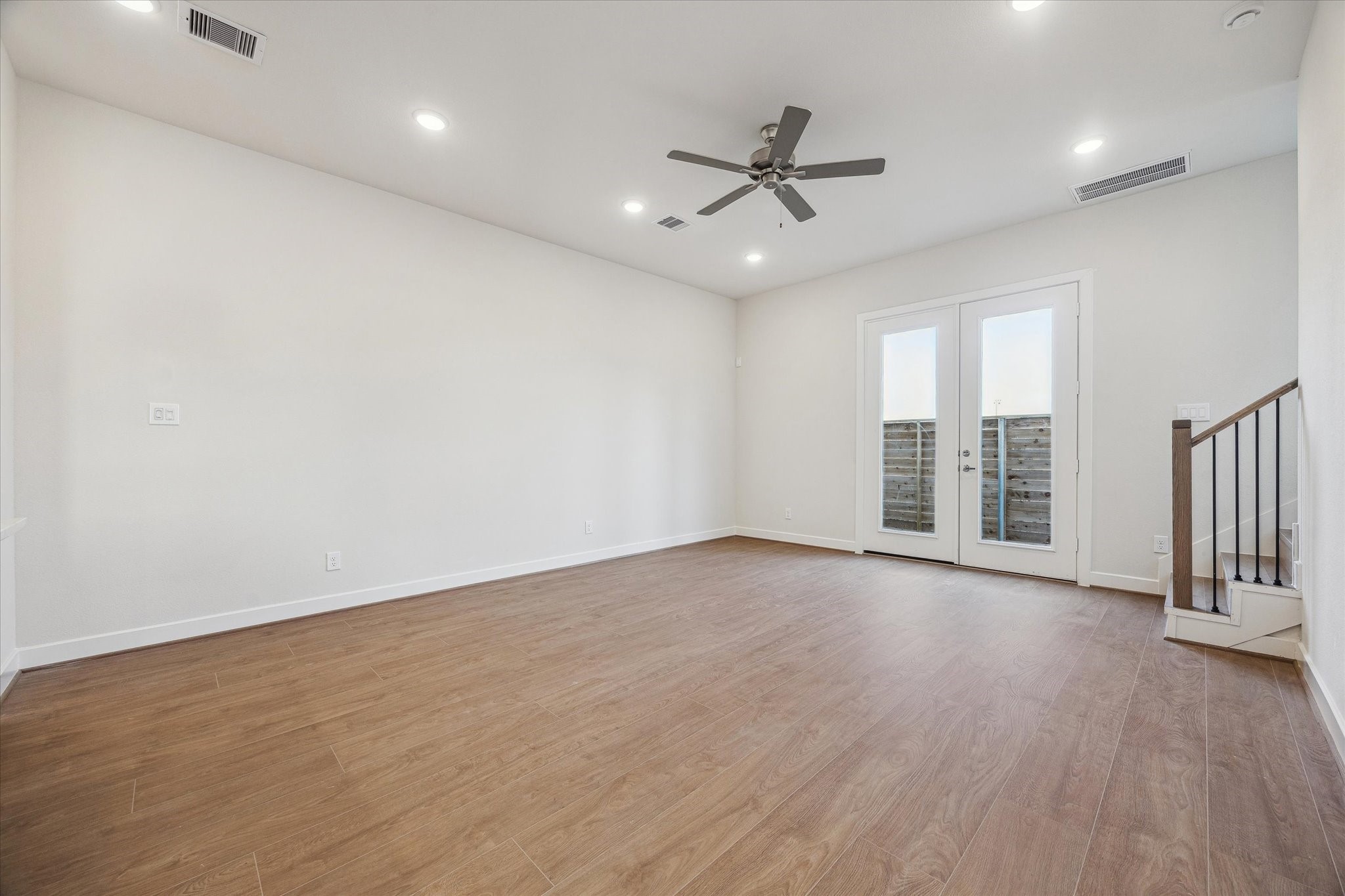 6519 Rena Street Houston, TX 77092 - Photo 5 of 11 an empty room with wooden floor fan and windows