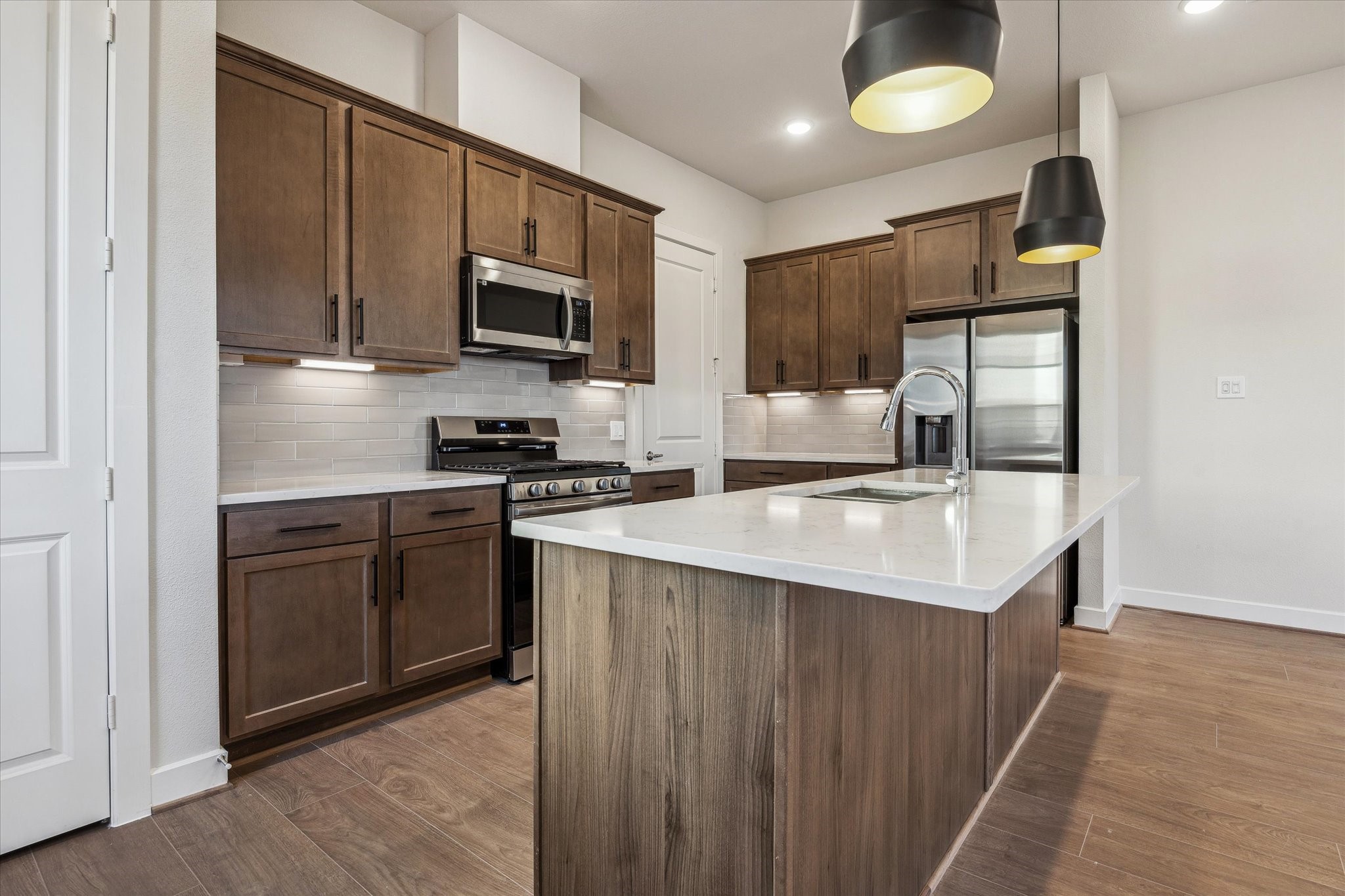 6519 Rena Street Houston, TX 77092 - Photo 6 of 11 a kitchen with stainless steel appliances granite countertop a sink stove microwave and refrigerator