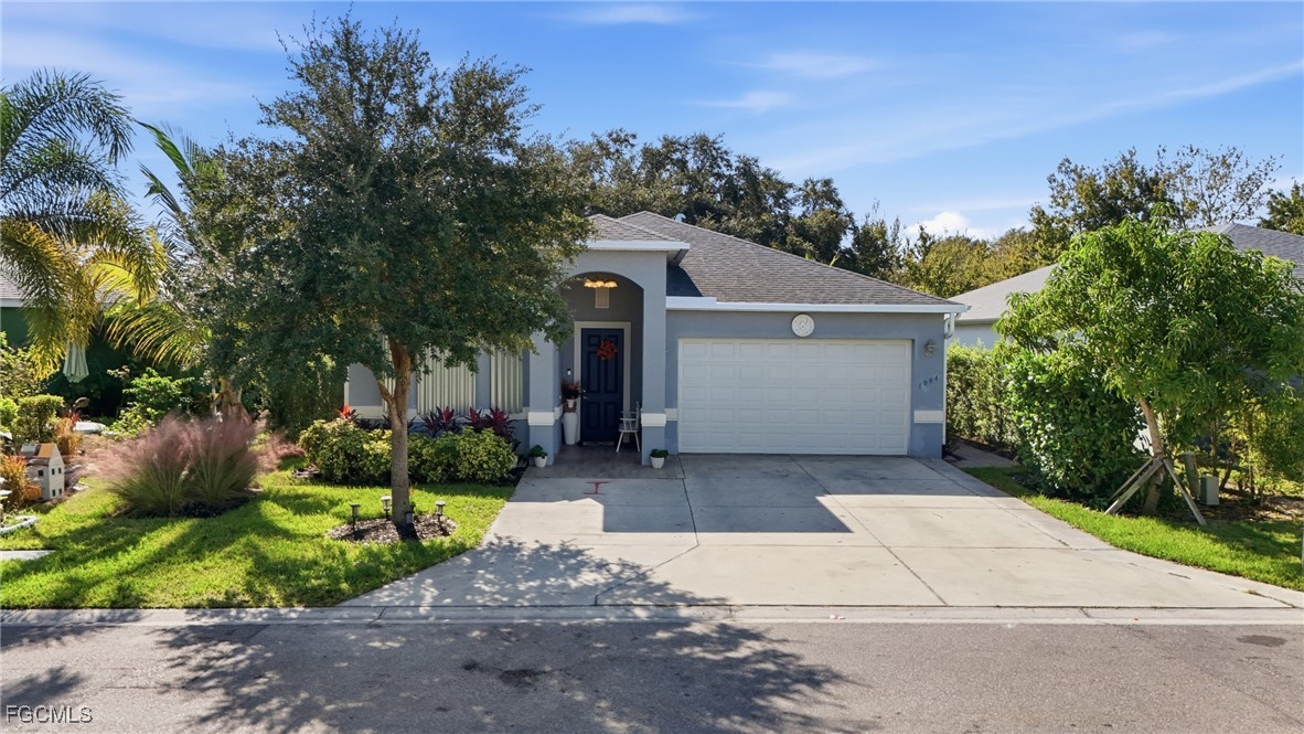 a front view of a house with a yard and potted plants
