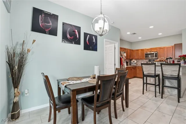 a view of a dining room with furniture and chandelier