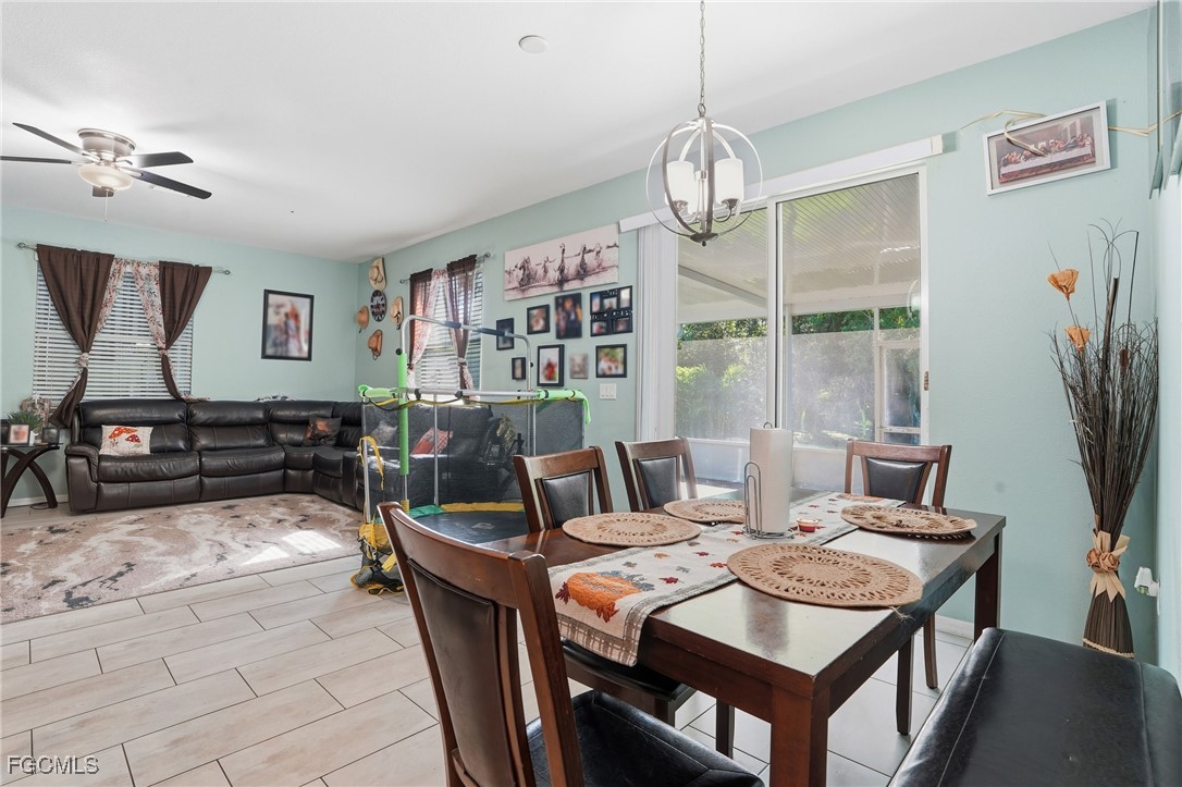 1004 Hamilton Street Immokalee, FL 34142 - Photo 14 of 45 a view of a dining room with furniture window and wooden floor