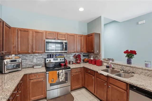 a kitchen with a sink stove and microwave