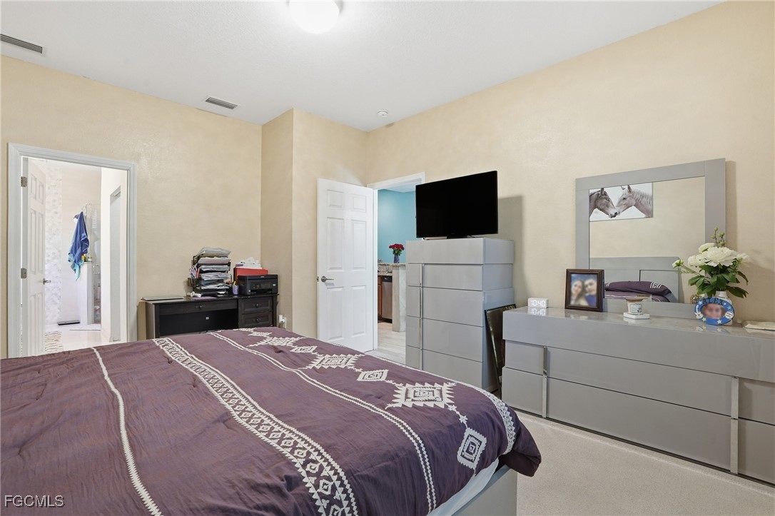 1004 Hamilton Street Immokalee, FL 34142 - Photo 22 of 45 a bedroom with a bed and a flat screen tv