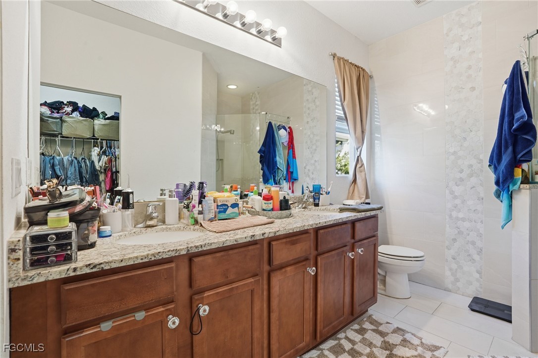 1004 Hamilton Street Immokalee, FL 34142 - Photo 23 of 45 a bathroom with a double vanity sink mirror and toilet