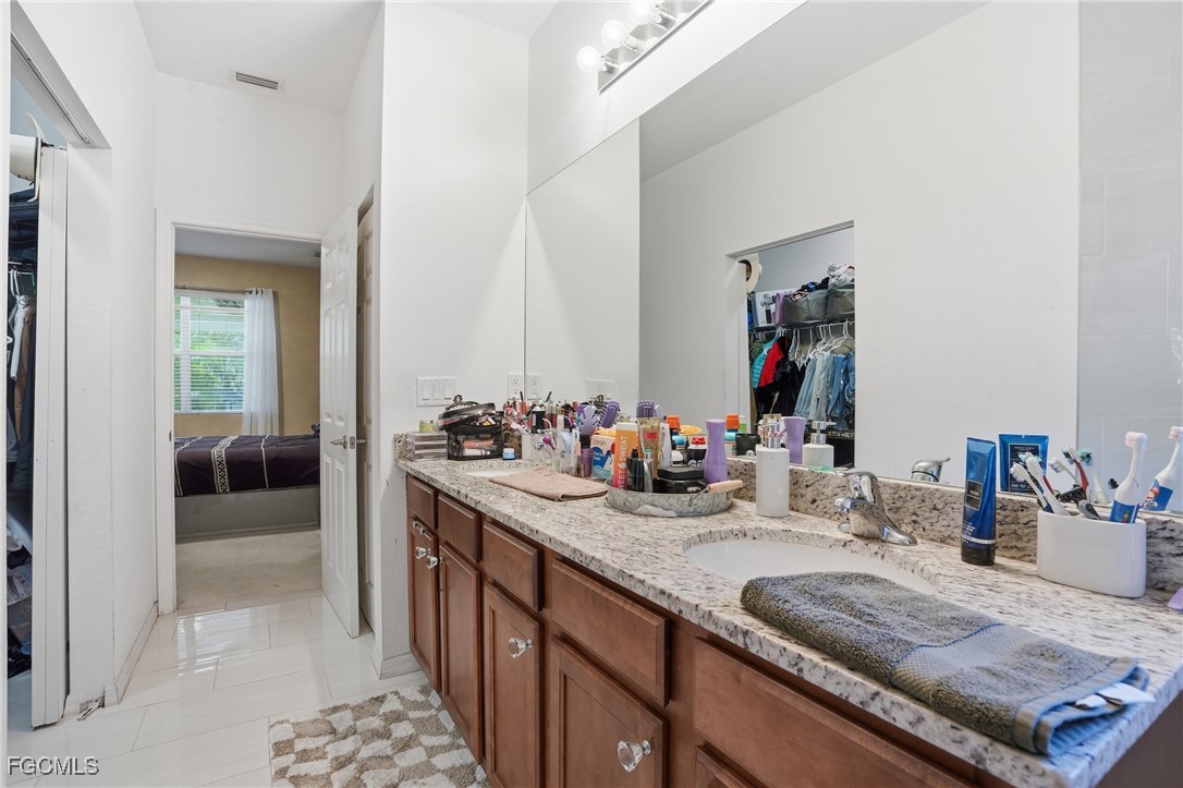 1004 Hamilton Street Immokalee, FL 34142 - Photo 24 of 45 a bathroom with sink and mirror