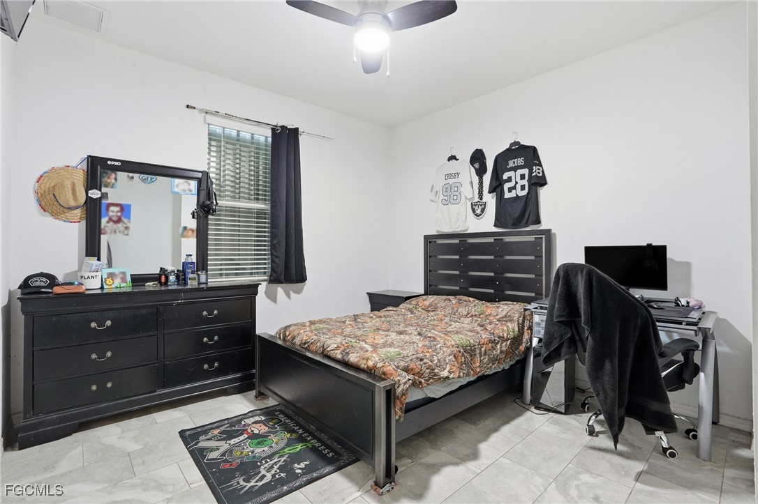 1004 Hamilton Street Immokalee, FL 34142 - Photo 28 of 45 a bedroom with a bed and furniture