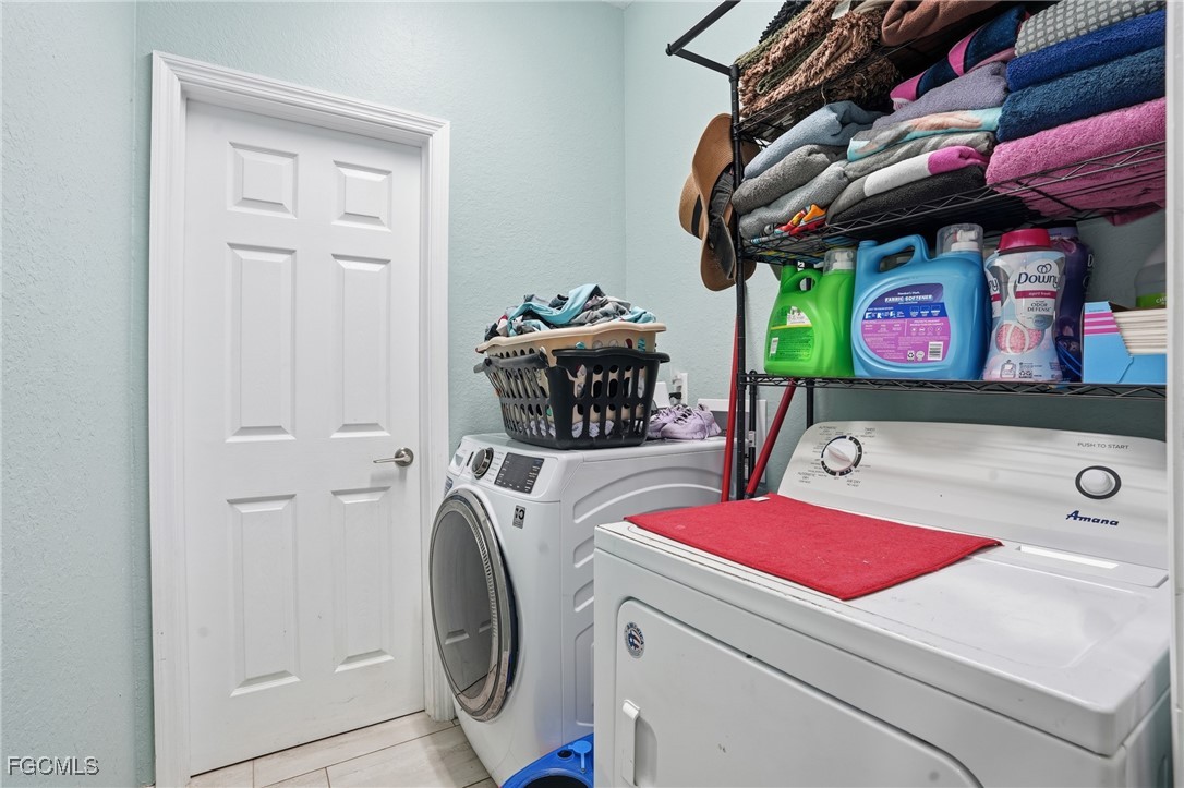1004 Hamilton Street Immokalee, FL 34142 - Photo 30 of 45 a utility room with dryer and washer