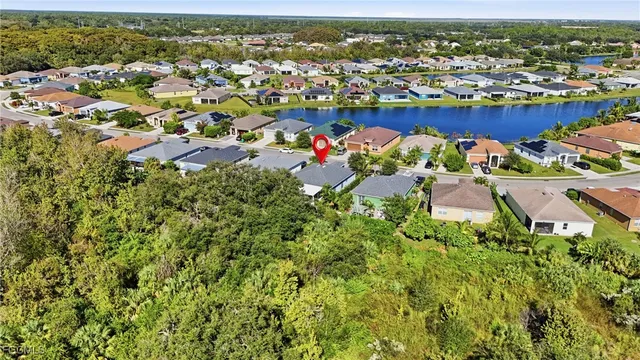 an aerial view of a houses with a swimming pool