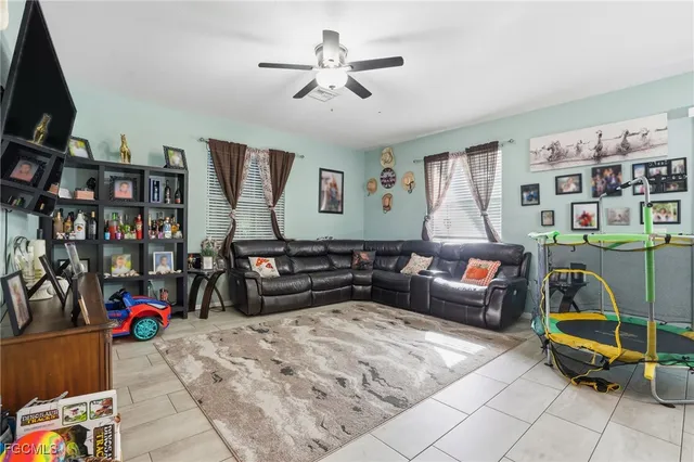 a living room with furniture a couch and a bookshelf