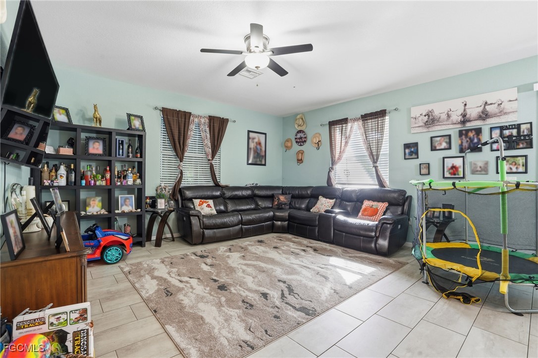 1004 Hamilton Street Immokalee, FL 34142 - Photo 7 of 45 a living room with furniture a couch and a bookshelf