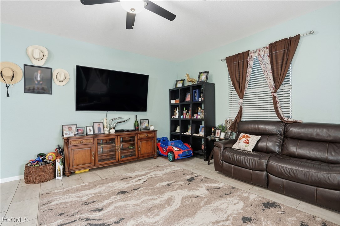 1004 Hamilton Street Immokalee, FL 34142 - Photo 10 of 45 a living room with furniture and a flat screen tv