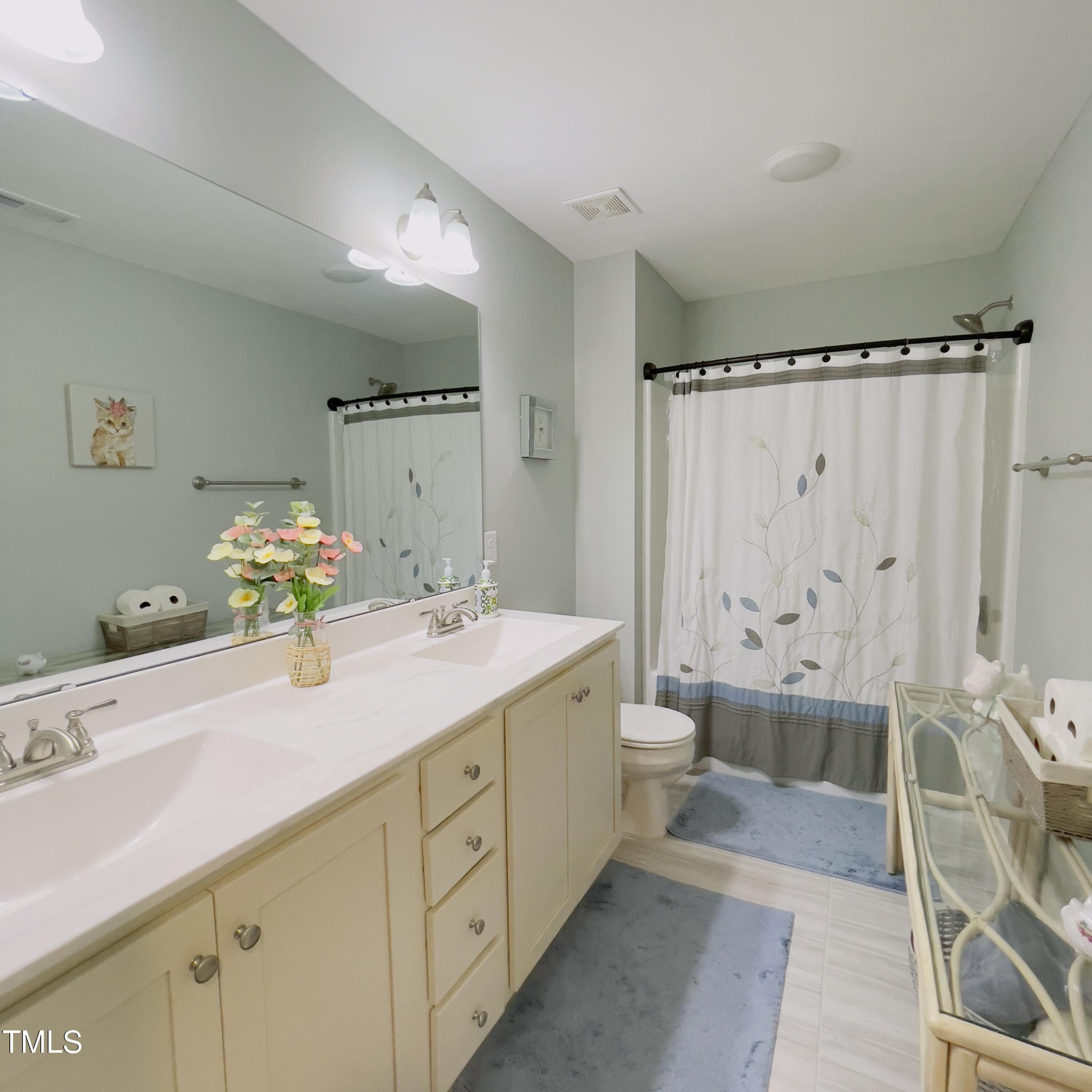 136 Unique Place Garner, NC 27529 - Photo 20 of 21 a spacious bathroom with a double vanity sink mirror and toilet