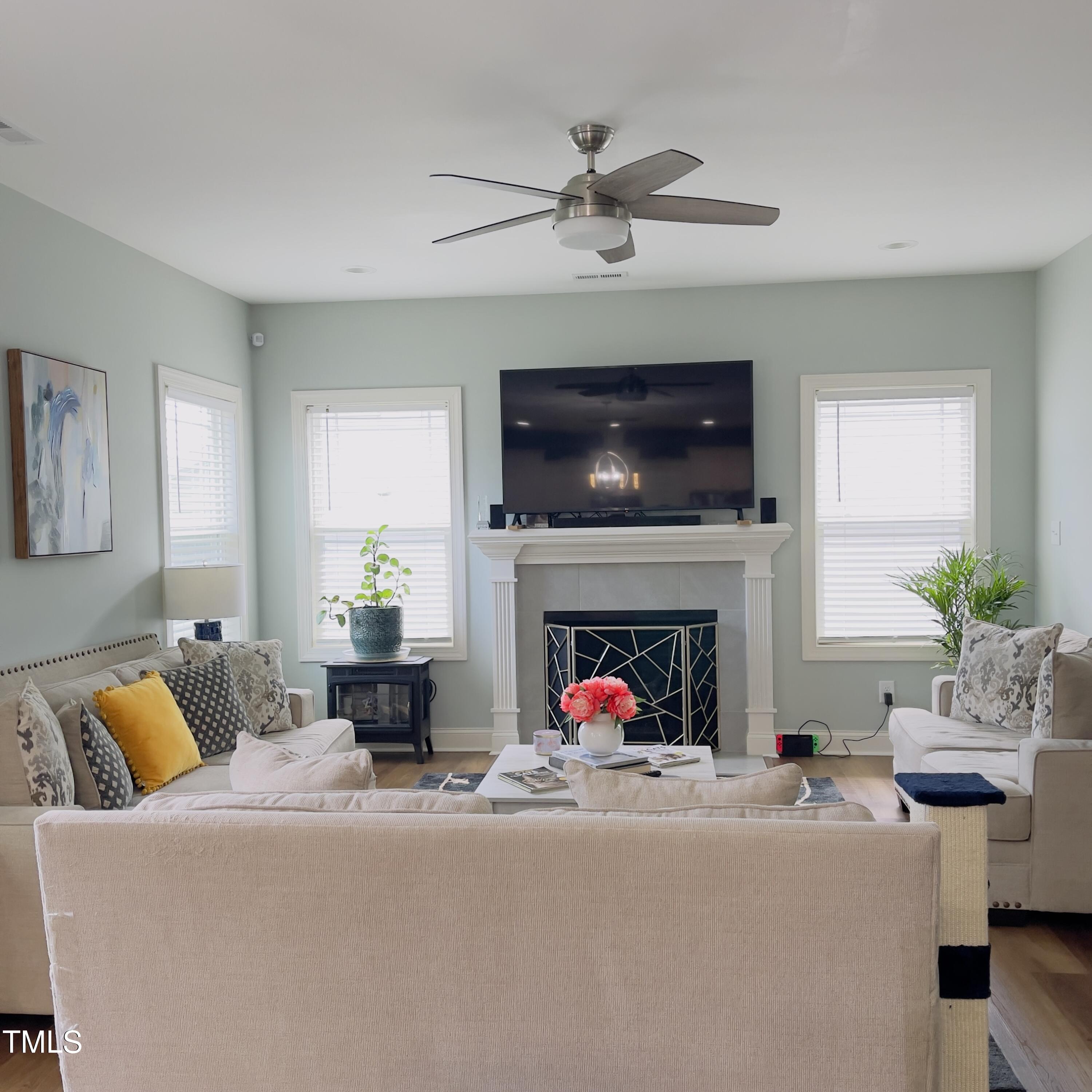 136 Unique Place Garner, NC 27529 - Photo 2 of 21 a living room with furniture a fireplace and a flat screen tv
