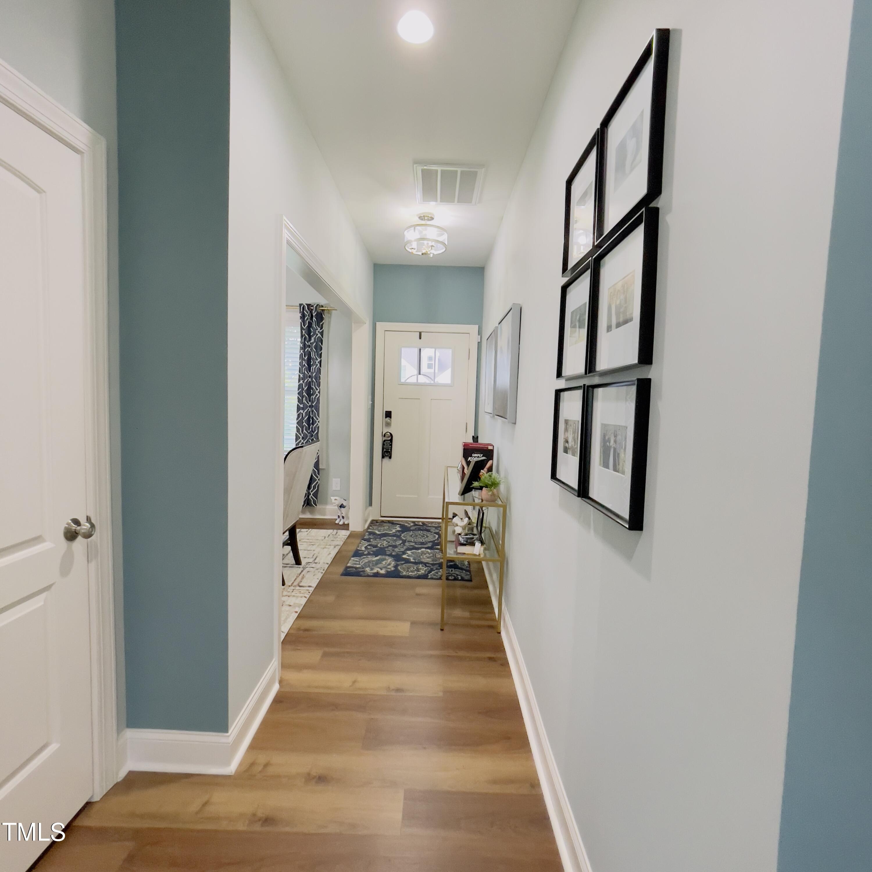 136 Unique Place Garner, NC 27529 - Photo 5 of 21 a view of a hallway with wooden floor and staircase
