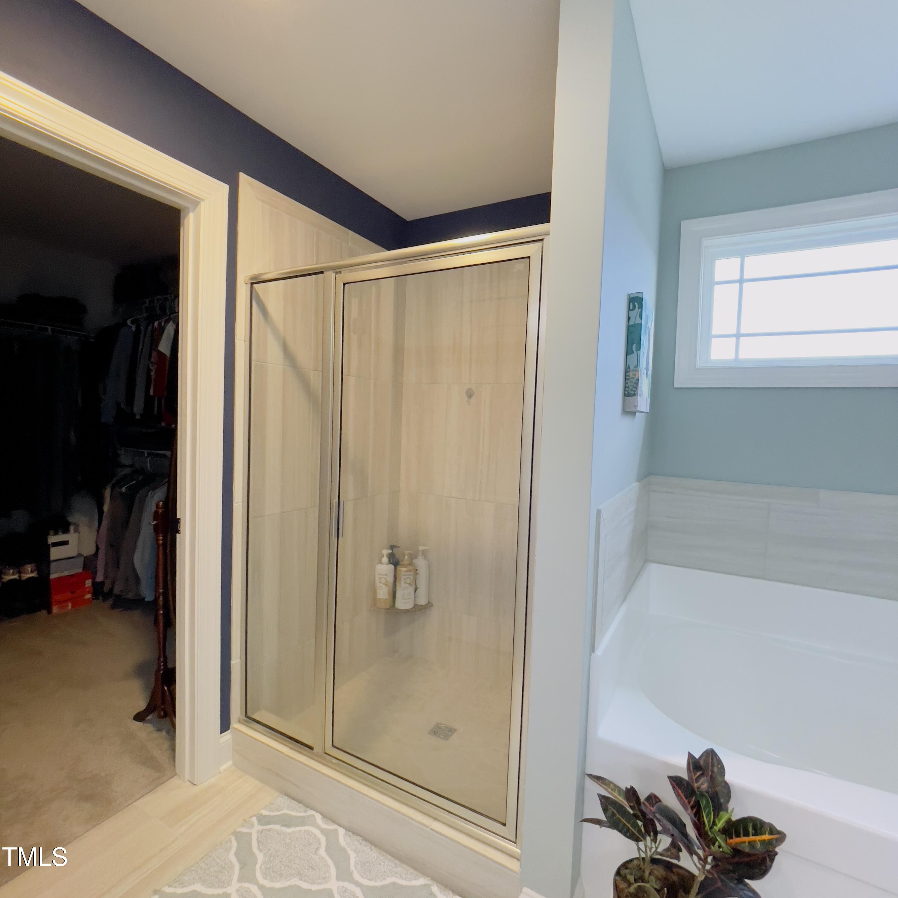 136 Unique Place Garner, NC 27529 - Photo 10 of 21 a bathroom with a shower and a tub
