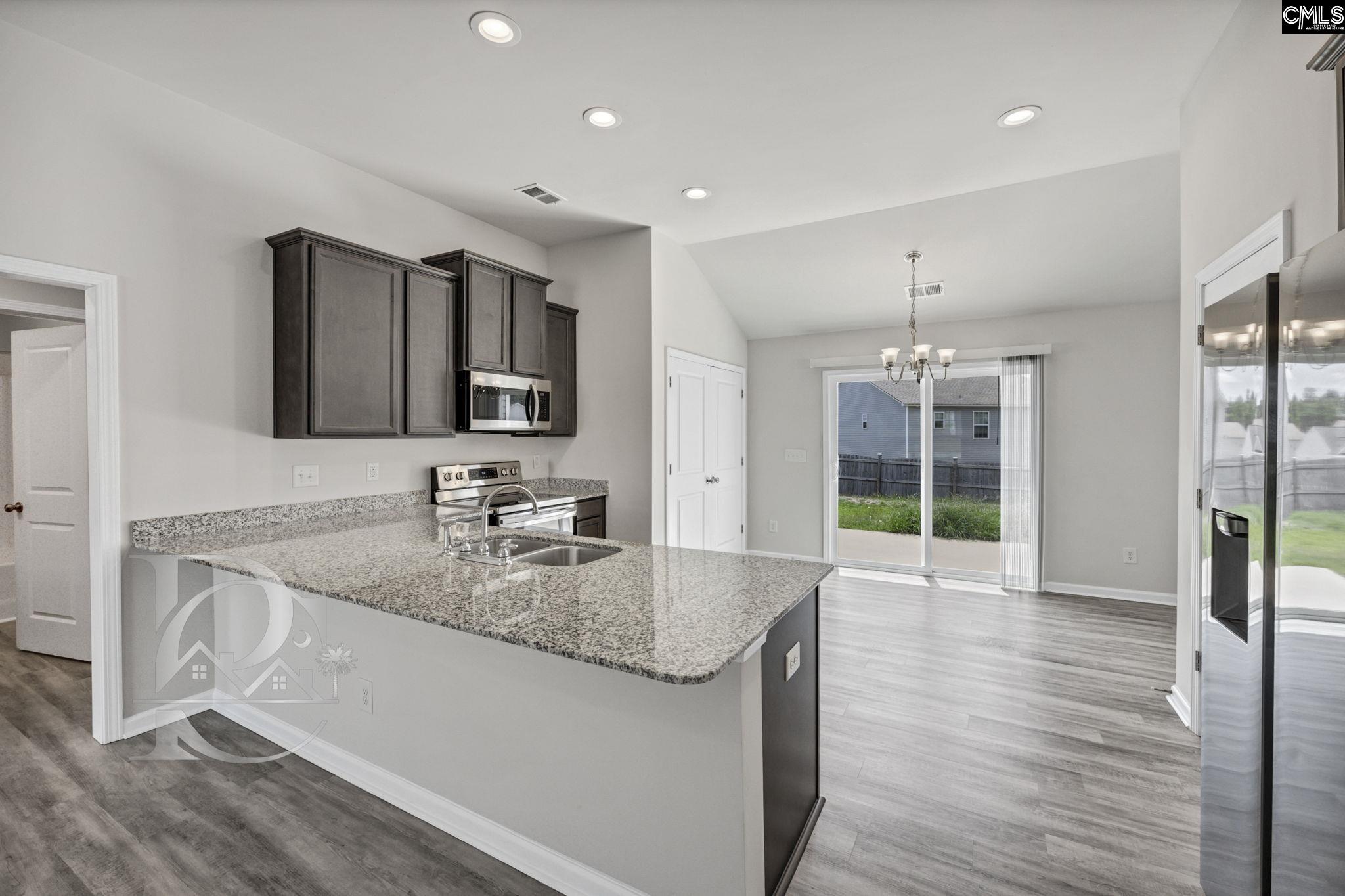235 Drayton Hall Road West Columbia, SC 29172 - Photo 7 of 24 a kitchen with stainless steel appliances granite countertop a sink a stove and a wooden floors