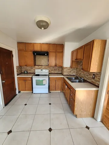 a kitchen with stainless steel appliances granite countertop a stove top oven and cabinets