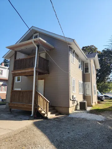 a view of house with backyard and deck