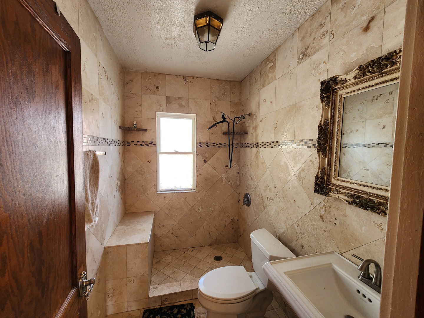 600 Sunderlin Street Waukegan, IL 60085 - Photo 5 of 12 a bathroom with a sink toilet and shower