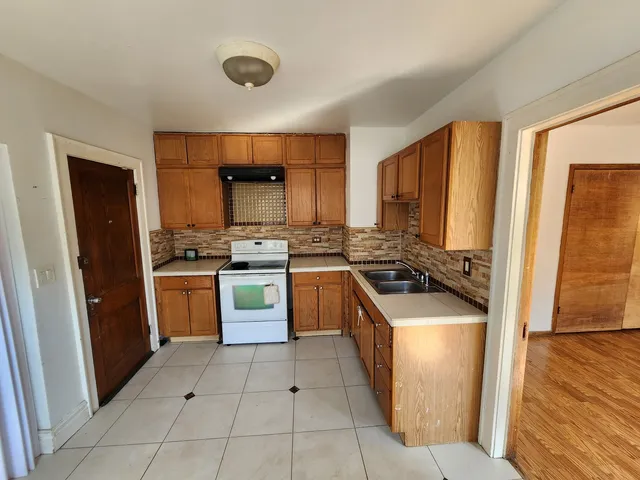 a kitchen with a stove a sink and a refrigerator