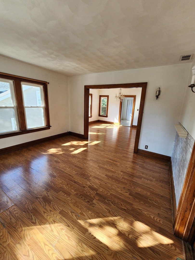 600 Sunderlin Street Waukegan, IL 60085 - Photo 10 of 12 a view of empty room with wooden floor and fan