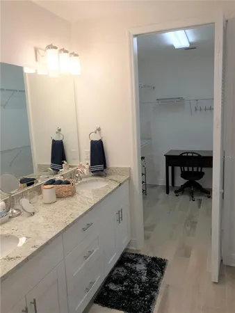 a bathroom with a double vanity sink and a mirror