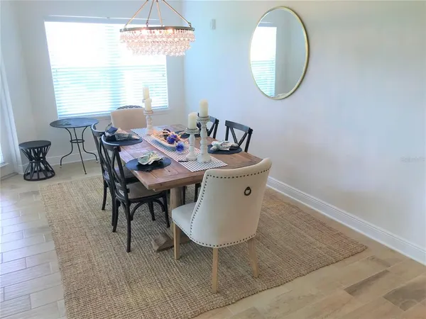 a dining room with furniture and a mirror