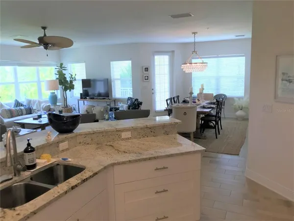 a kitchen with sink refrigerator and window