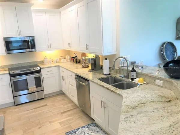a kitchen with a sink and a stove top oven
