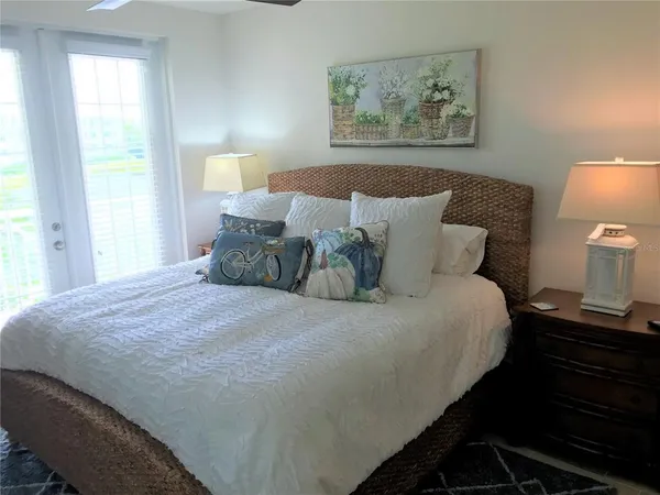 a bedroom with bed and lamps with wooden floor