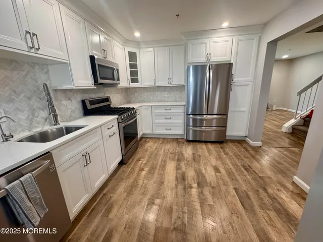 a kitchen with a refrigerator stove and microwave