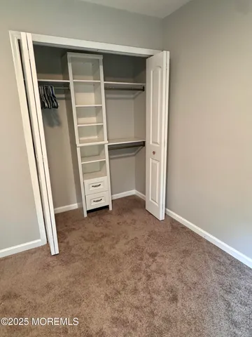 a view of room with a closet and a cabinet