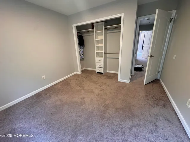 an empty room with a fireplace and cabinet