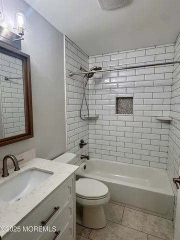 a bathroom with a sink a toilet and bathtub