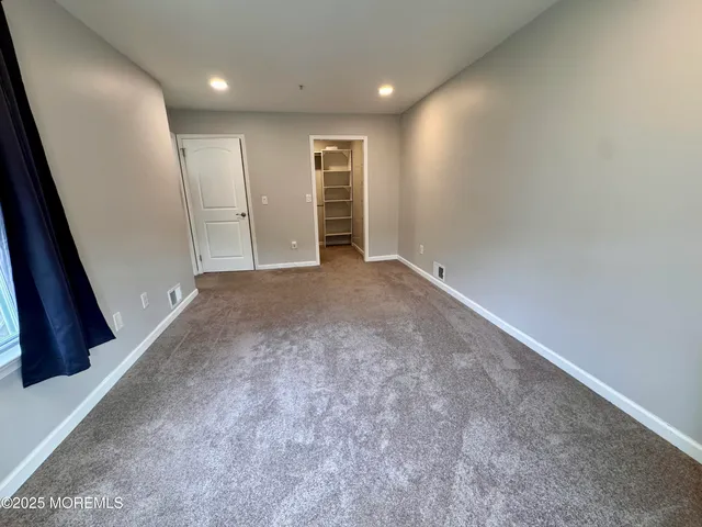 an empty room with an entrance to other room