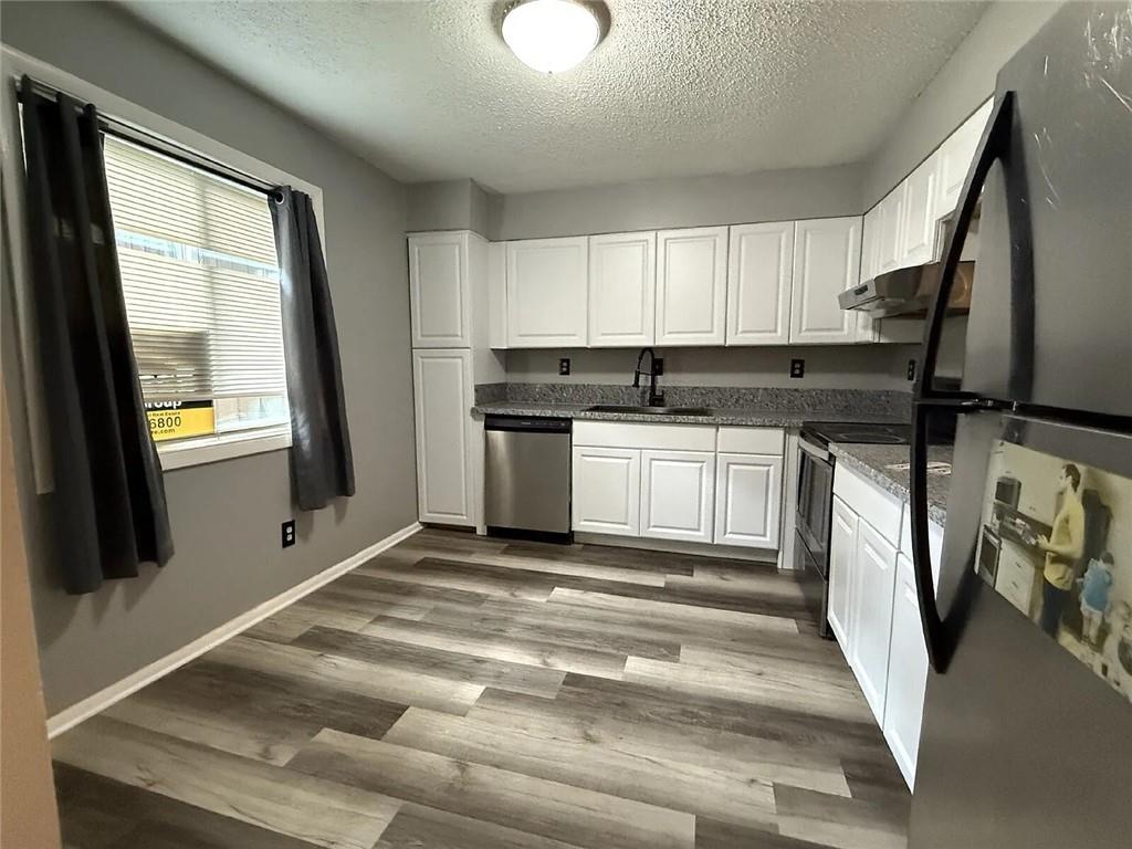 20 Quail Run Decatur, GA 30035 - Photo 6 of 15 a kitchen with stainless steel appliances granite countertop a stove a sink and a refrigerator
