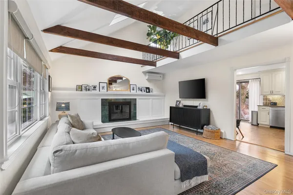 a living room with furniture a flat screen tv and a fireplace