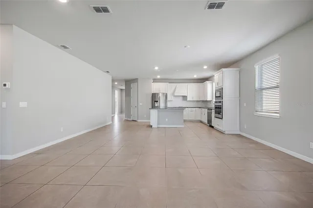 a view of a kitchen with a sink and white cabinets