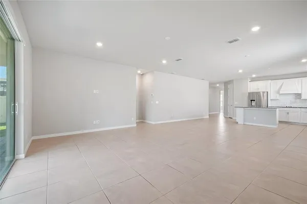 a view of a kitchen with a sink and a refrigerator